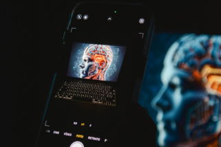 a cell phone sitting on top of a laptop computer